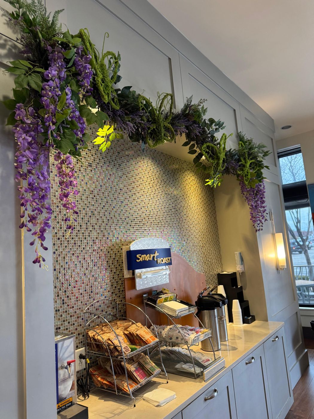 Wisteria garland framing a coffee station