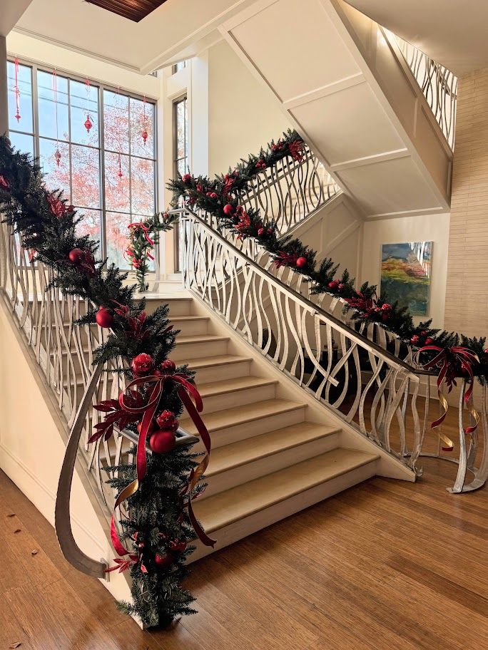 Staircase garland with red ribbon and ornaments