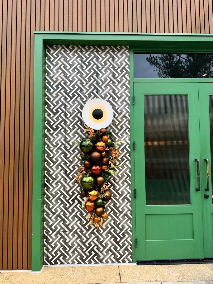 Copper, green and orange ornament door swag at a restaurant entrance