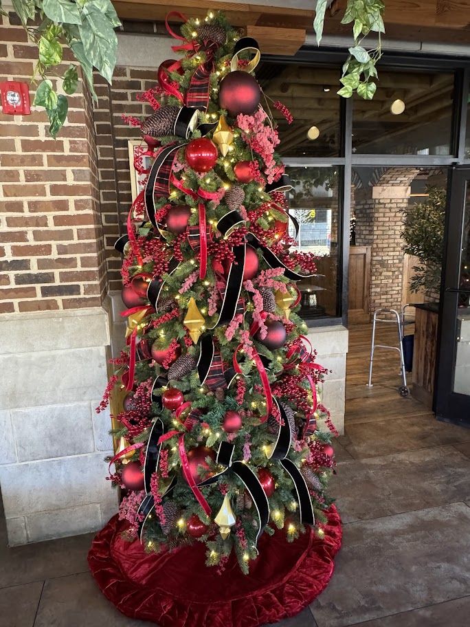 Red and black plaid ribbon Christmas tree with velvet skirt