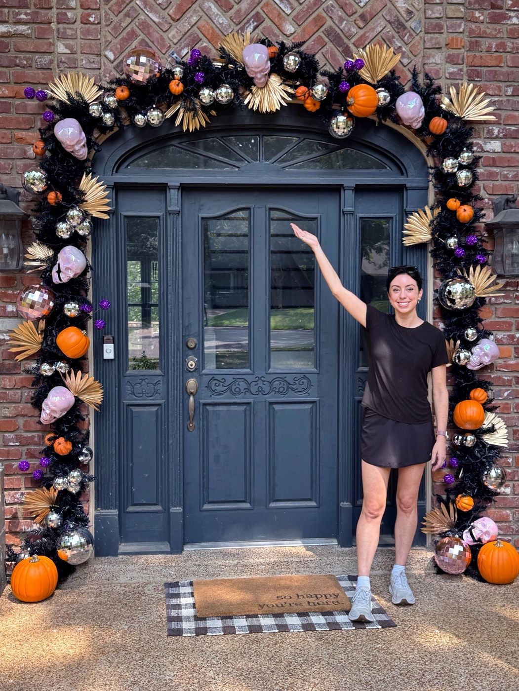 Halloween door arch with skulls, pumpkins, disco balls and gold palms