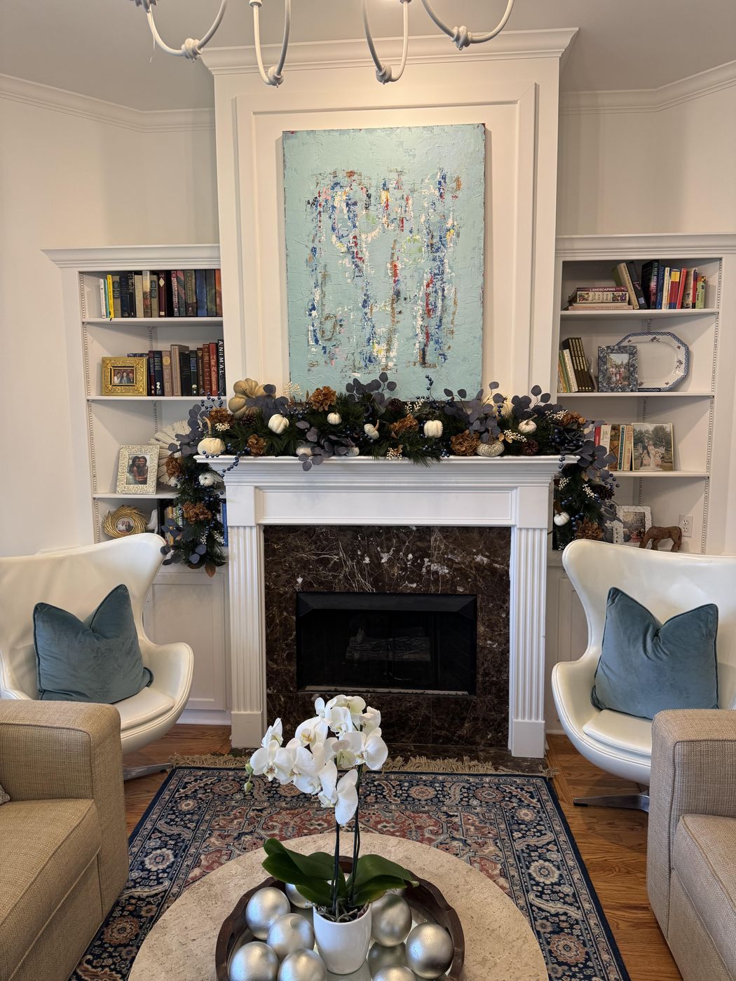 Navy berry and white-pumpkin fall garland on a living-room mantel
