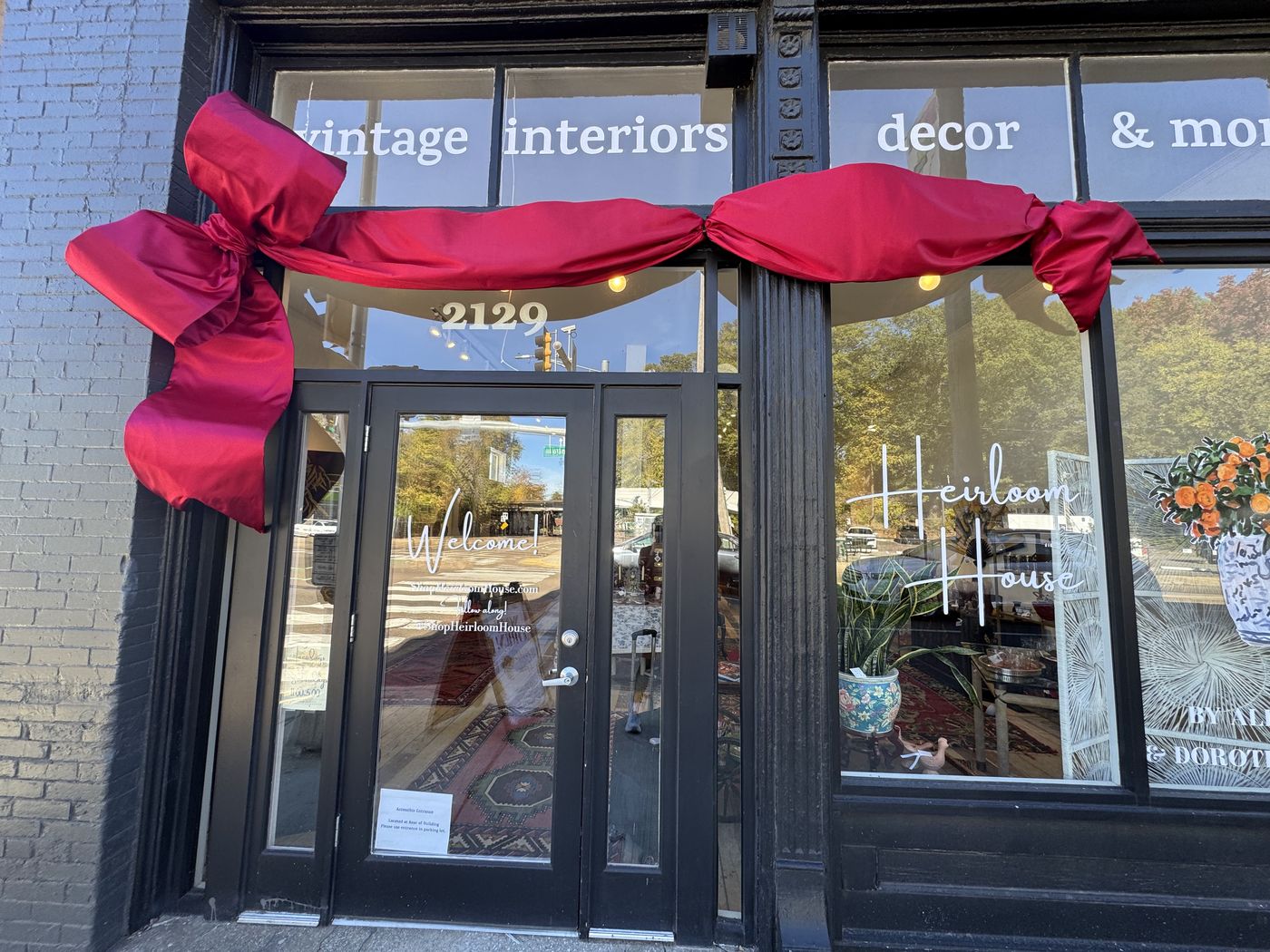 Heirloom House storefront with a large red holiday bow